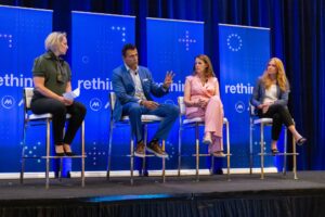 Panelists discuss manufacturing leadership on a conference stage